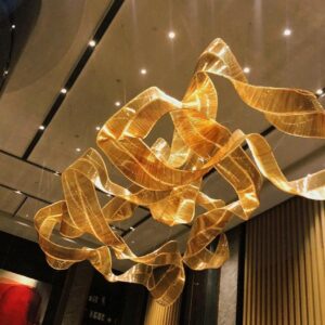 Modern designer chandelier suspended above marble dining table